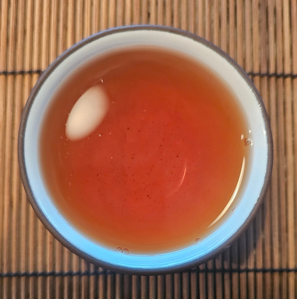 This 2002 Green Tree Sheng from Menghai is aged in Malaysian clay urns. Strong, sweet, and balanced—classic Menghai power softened with time.