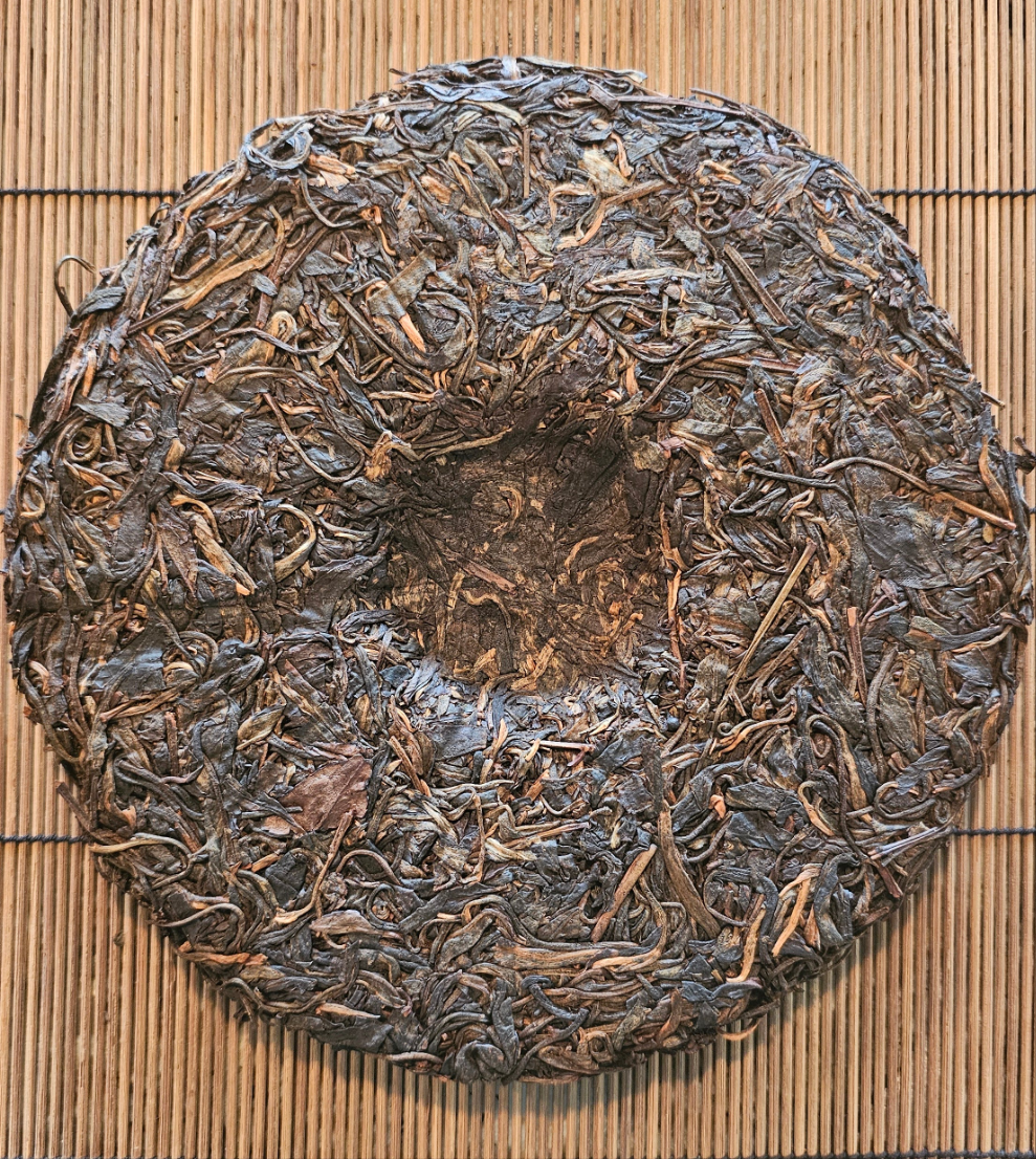 A smooth and balanced Yiwu Sheng from 2005, aged in Malaysian clay urns. Sweet minerality, forest floor aroma, and soft opening chi define this classic.