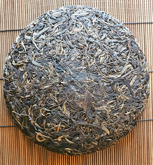 Pressed 2017 Lao Ban Zhang Citrine Sheng cake with golden wrapper