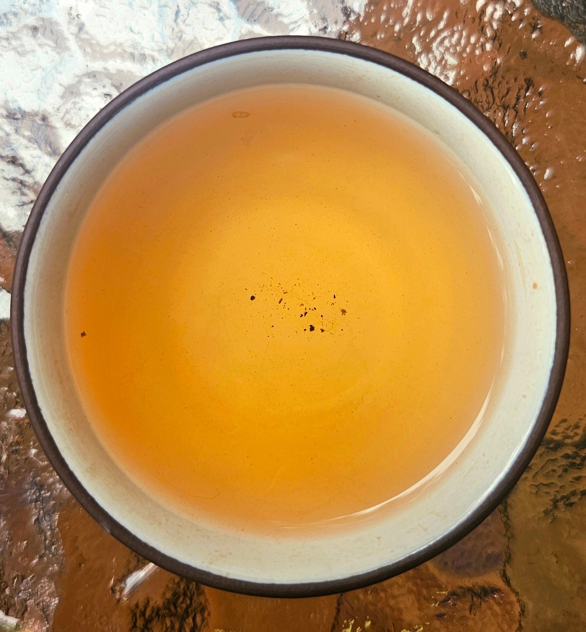 Citrine tea liquor glowing amber with intense aroma