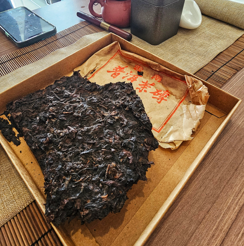 25-year dry aged puerh tea titled Sweet Forest Medicine with golden aged edges
